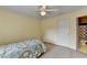 Bedroom featuring a bed, a window with blinds, ceiling fan, and access to a bathroom at 5980 Whitestone Ln, Suwanee, GA 30024