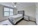 Bright bedroom with a ceiling fan, large window, and tufted headboard bed frame at 5980 Whitestone Ln, Suwanee, GA 30024