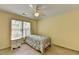 Bedroom with a metal framed bed, a ceiling fan, and window with blinds at 5980 Whitestone Ln, Suwanee, GA 30024