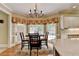 Cozy breakfast nook with a chandelier and views of the backyard at 5980 Whitestone Ln, Suwanee, GA 30024