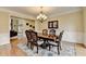 Comfortable dining room with hardwood floors, a chandelier, and an ornate area rug at 5980 Whitestone Ln, Suwanee, GA 30024
