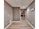 Finished basement hallway with gray walls and light wood flooring at 5980 Whitestone Ln, Suwanee, GA 30024