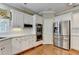 Clean, modern kitchen with stainless steel appliances and white cabinets at 5980 Whitestone Ln, Suwanee, GA 30024