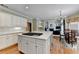Open kitchen with a large island, stainless steel appliances, and adjacent breakfast nook at 5980 Whitestone Ln, Suwanee, GA 30024