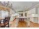 Spacious kitchen with a large island, white cabinets, and hardwood floors at 5980 Whitestone Ln, Suwanee, GA 30024