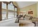 Bright living room with a fireplace, large windows, and views of the pool at 5980 Whitestone Ln, Suwanee, GA 30024