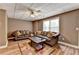 Cozy living room with hardwood floors, plush couches, and plenty of natural light at 5980 Whitestone Ln, Suwanee, GA 30024