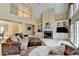 Open-concept living room with fireplace, built-ins, high ceilings, and large windows at 5980 Whitestone Ln, Suwanee, GA 30024