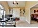 Vaulted ceiling home office featuring built-in shelving and natural light, perfect for remote work at 5980 Whitestone Ln, Suwanee, GA 30024