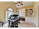 Bright home office with built-in shelving, a vaulted ceiling, and a large window at 5980 Whitestone Ln, Suwanee, GA 30024