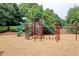 Community playground with slides, ladders, and climbing equipment in a natural setting at 5980 Whitestone Ln, Suwanee, GA 30024