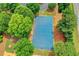 Aerial view of a full-size outdoor tennis court with green landscaping at 5980 Whitestone Ln, Suwanee, GA 30024