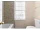 Neutral-toned bathroom featuring modern tile work and white toilet at 971 Ashebrooke Ne Ct, Marietta, GA 30068
