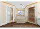 Bright bathroom featuring a large soaking tub with decorative glass window and a separate glass-enclosed shower at 971 Ashebrooke Ne Ct, Marietta, GA 30068