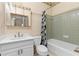 Bathroom with bathtub and shower combo, patterned wallpaper and matching shower curtain at 971 Ashebrooke Ne Ct, Marietta, GA 30068
