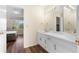 Bathroom with white cabinets, dual sinks, quartz countertop and view of the bedroom at 971 Ashebrooke Ne Ct, Marietta, GA 30068