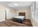 Bedroom with wood-look floors, a bed and a bright window, offering a comfortable space at 971 Ashebrooke Ne Ct, Marietta, GA 30068