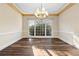Dining room featuring decorative chandelier, crown molding, and large window at 971 Ashebrooke Ne Ct, Marietta, GA 30068