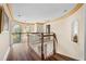 Hallway with wood floors, white railings, and ornate ceiling trim at 971 Ashebrooke Ne Ct, Marietta, GA 30068