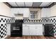 Charming kitchen featuring white cabinets, modern countertops and a black dishwasher at 971 Ashebrooke Ne Ct, Marietta, GA 30068