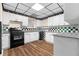 Charming kitchen with white cabinets, a black stove and modern countertops at 971 Ashebrooke Ne Ct, Marietta, GA 30068