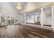Open-concept living room with wood floors leading to a kitchen and staircase at 971 Ashebrooke Ne Ct, Marietta, GA 30068