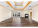 Living room features a fireplace, tray ceiling, wood floors, and french doors to a patio at 971 Ashebrooke Ne Ct, Marietta, GA 30068