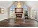Bright living room with hardwood floors, fireplace, chandelier, and large windows at 971 Ashebrooke Ne Ct, Marietta, GA 30068