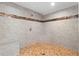 Tiled walk-in shower featuring a mosaic accent stripe, built-in bench, and patterned tile floor at 971 Ashebrooke Ne Ct, Marietta, GA 30068