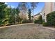 An expansive lawn featuring evergreen trees and mature shrubs at 971 Ashebrooke Ne Ct, Marietta, GA 30068
