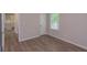 Bedroom with light gray walls, wood-look flooring, a window, and white trim at 525 Baker Nw Cir, Atlanta, GA 30318