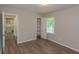 Bright bedroom with wood-look floors, closet and doorway view to kitchen at 525 Baker Nw Cir, Atlanta, GA 30318