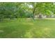 The home has a spacious yard, mature trees, and a charming exterior at 525 Baker Nw Cir, Atlanta, GA 30318