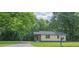 A cozy single-story home surrounded by lush trees and greenery at 525 Baker Nw Cir, Atlanta, GA 30318