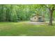 Charming home featuring a well-manicured lawn and surrounded by mature trees, offering a serene setting at 525 Baker Nw Cir, Atlanta, GA 30318