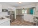 Modern kitchen showcasing stainless steel appliances, white cabinets, and view to living room at 525 Baker Nw Cir, Atlanta, GA 30318