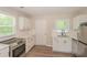Bright kitchen featuring stainless steel appliances, white cabinets, and natural lighting at 525 Baker Nw Cir, Atlanta, GA 30318
