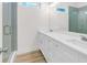 Bathroom with double vanity, quartz countertops, modern fixtures, and a glass-enclosed shower at 614 Glendale Rd, Scottdale, GA 30079
