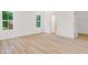 Bedroom with hardwood floors and natural light from two windows at 614 Glendale Rd, Scottdale, GA 30079