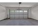 A spacious two-car garage featuring a bright interior, epoxy flooring and an insulated garage door at 614 Glendale Rd, Scottdale, GA 30079
