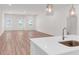 Spacious living room with hardwood floors, white walls, and modern lighting fixtures at 614 Glendale Rd, Scottdale, GA 30079