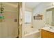 Bathroom featuring a separate shower, tub, and single vanity with decorative shelf at 809 Longbranch Ln, Douglasville, GA 30134