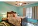 Cozy bedroom featuring an ornate bed frame, floral bedding and aqua colored walls at 809 Longbranch Ln, Douglasville, GA 30134