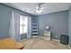 Well lit bedroom features blue walls, white trim, and carpeted floors at 809 Longbranch Ln, Douglasville, GA 30134