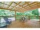 Spacious covered deck featuring outdoor seating, ideal for relaxing and enjoying the wooded backyard view at 809 Longbranch Ln, Douglasville, GA 30134