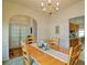 Cozy dining room featuring a wooden table, chandelier, and access to the kitchen at 809 Longbranch Ln, Douglasville, GA 30134