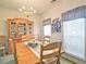 Bright dining area with a wooden table set for six and a large china cabinet at 809 Longbranch Ln, Douglasville, GA 30134
