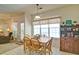 Bright dining room boasts a wooden table with seating for four, complemented by natural light and charming decor at 809 Longbranch Ln, Douglasville, GA 30134