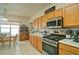 Well-equipped kitchen showcases ample wooden cabinetry, stainless steel appliances, and a view into the adjacent dining area at 809 Longbranch Ln, Douglasville, GA 30134