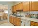 Bright kitchen offers wooden cabinetry, ample counter space, and views into the dining area, perfect for gatherings at 809 Longbranch Ln, Douglasville, GA 30134